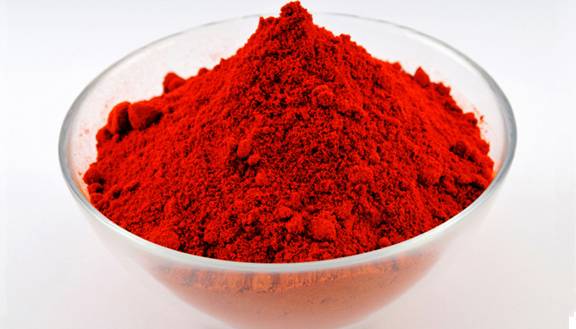Red paprika powder in a round glass