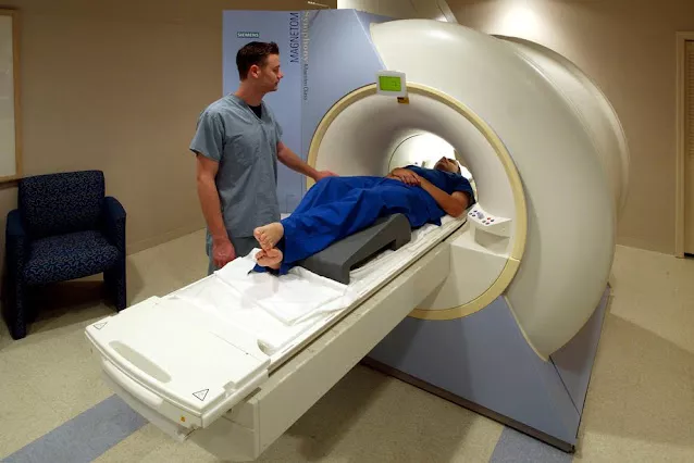 doctor showing patient MRI and X-ray scans comparison